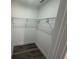 Walk-in closet with white walls, gray wood floors, and wire shelving at 21215 Cottonwood Ave, Port Charlotte, FL 33952
