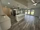Modern kitchen with white cabinets, a spacious island, stainless steel appliances, and an open layout to the living area at 21215 Cottonwood Ave, Port Charlotte, FL 33952