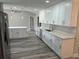 Updated kitchen with white cabinetry, stainless steel appliances, ample countertop space, and modern flooring at 21215 Cottonwood Ave, Port Charlotte, FL 33952