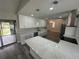 Modern kitchen with white cabinets, stainless appliances, and a large island, open to the living space at 21215 Cottonwood Ave, Port Charlotte, FL 33952