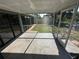 Enclosed lanai with a stone-like patio and views of the backyard at 21215 Cottonwood Ave, Port Charlotte, FL 33952