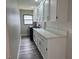 Laundry room featuring white cabinets and counter tops, a window, washer, and dryer at 21215 Cottonwood Ave, Port Charlotte, FL 33952