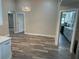 Open-concept living area with modern flooring, updated lighting fixture and neutral color palette at 21215 Cottonwood Ave, Port Charlotte, FL 33952