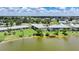 Aerial view of lakefront community condos with a wooden pier for residents to relax and enjoy the water at 25225 Rampart Blvd # 1607, Punta Gorda, FL 33983