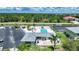 Aerial view of the community swimming pool, surrounded by palm trees, cabanas, and lush landscaping at 25225 Rampart Blvd # 1607, Punta Gorda, FL 33983