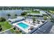 Community condos feature a refreshing pool, cabana, seating, and palm trees near a serene lake at 25225 Rampart Blvd # 1607, Punta Gorda, FL 33983