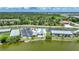 Aerial view of the community's pristine pool with a cabana, palm trees, and lakefront condos at 25225 Rampart Blvd # 1607, Punta Gorda, FL 33983