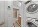 This bathroom features a shower and tub combo and updated vanity with laundry machines in the hallway at 25225 Rampart Blvd # 1607, Punta Gorda, FL 33983