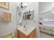 This bathroom features a single sink vanity, mirrored medicine cabinet, and view into a bedroom at 25225 Rampart Blvd # 1607, Punta Gorda, FL 33983