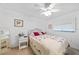 Bedroom features a ceiling fan, wicker furniture, and a comfortable bed with patterned bedding at 25225 Rampart Blvd # 1607, Punta Gorda, FL 33983