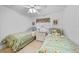 This cozy bedroom features two twin beds, ceiling fan, and neutral wall color and flooring at 25225 Rampart Blvd # 1607, Punta Gorda, FL 33983