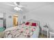 Bright bedroom with a ceiling fan, wicker accents, and an ensuite bathroom, offering comfort and convenience at 25225 Rampart Blvd # 1607, Punta Gorda, FL 33983