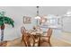 Cozy dining area with rattan chairs, glass table, and view of the kitchen's breakfast bar at 25225 Rampart Blvd # 1607, Punta Gorda, FL 33983