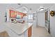 Cozy kitchen featuring white appliances, wood cabinets, and a functional countertop at 25225 Rampart Blvd # 1607, Punta Gorda, FL 33983