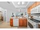 This kitchen featuring white appliances blends seamlessly into the cozy living space at 25225 Rampart Blvd # 1607, Punta Gorda, FL 33983