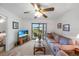 Bright living room with sliding glass doors to the balcony, a ceiling fan, and comfortable furnishings at 25225 Rampart Blvd # 1607, Punta Gorda, FL 33983