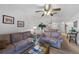 Cozy living room features sofas, a fan, and an open layout that transitions into the dining area at 25225 Rampart Blvd # 1607, Punta Gorda, FL 33983