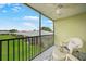 This screened in patio has a relaxing chair with a green lawn view at 25225 Rampart Blvd # 1607, Punta Gorda, FL 33983
