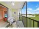 This screened in patio has a relaxing chair with a lake view at 25225 Rampart Blvd # 1607, Punta Gorda, FL 33983