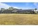 Large backyard with screened pool and bushes around fence at 26194 Rampart Blvd, Punta Gorda, FL 33983