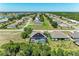 An aerial view showcases a home with a screened-in pool in a neighborhood with tree-lined streets at 2636 Mauritania Rd, Punta Gorda, FL 33983