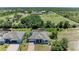 An aerial view showcases a home with a screened-in lanai and well-maintained landscaping near a school at 2636 Mauritania Rd, Punta Gorda, FL 33983