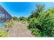 Large backyard featuring lush landscaping, providing shade and privacy at 2636 Mauritania Rd, Punta Gorda, FL 33983