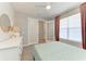 This bedroom features natural light, with a large dresser, decorative mirror, and french doors at 2636 Mauritania Rd, Punta Gorda, FL 33983