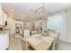 Open concept kitchen and dining area with modern light fixture and access to the living room at 2636 Mauritania Rd, Punta Gorda, FL 33983