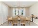Elegant dining room with a modern light fixture and large windows providing natural light at 2636 Mauritania Rd, Punta Gorda, FL 33983