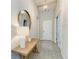 Bright entryway features a wooden bench, decorative mirror, pendant lighting, and wood-look tile flooring at 2636 Mauritania Rd, Punta Gorda, FL 33983