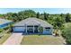 Charming single-story home boasts a well-manicured lawn, two-car garage, and inviting front porch at 2636 Mauritania Rd, Punta Gorda, FL 33983