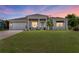 Charming single-story home with a well-maintained lawn and inviting front porch at 2636 Mauritania Rd, Punta Gorda, FL 33983