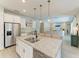 Bright kitchen island has granite countertops and seating, plus stainless steel appliances and decor at 2636 Mauritania Rd, Punta Gorda, FL 33983