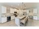 Modern kitchen features white cabinetry, granite countertops, stainless steel appliances, and a breakfast bar at 2636 Mauritania Rd, Punta Gorda, FL 33983