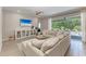 Inviting living room with comfortable seating, ceiling fan, and sliding glass doors to the lanai at 2636 Mauritania Rd, Punta Gorda, FL 33983