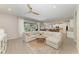 Bright living room features tile floors, a ceiling fan, and access to the outdoor patio at 2636 Mauritania Rd, Punta Gorda, FL 33983