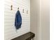 Mudroom with white shiplap accent wall with hooks, a dark stone bench, and ample space at 2636 Mauritania Rd, Punta Gorda, FL 33983