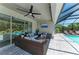 Covered patio with comfortable seating, ceiling fan, and view of the pool at 2636 Mauritania Rd, Punta Gorda, FL 33983