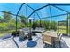This screened patio features comfortable seating and a dining area, perfect for outdoor entertaining and relaxation at 2636 Mauritania Rd, Punta Gorda, FL 33983