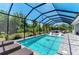 Sparkling pool with screened enclosure, lounge chairs, and patio area for relaxation at 2636 Mauritania Rd, Punta Gorda, FL 33983