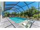 Inviting screened pool with lounge chairs, offering a perfect outdoor retreat at 2636 Mauritania Rd, Punta Gorda, FL 33983