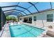 Sparkling pool enclosed with a screen, and an entertainment patio with seating and outdoor dining at 2636 Mauritania Rd, Punta Gorda, FL 33983