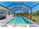 This luxurious screened-in pool area features elegant lounge chairs and lush landscaping for ultimate relaxation at 2636 Mauritania Rd, Punta Gorda, FL 33983
