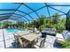 Enclosed pool area with outdoor seating and dining space for entertaining Gathering and friends at 2636 Mauritania Rd, Punta Gorda, FL 33983