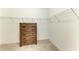 White walk in closet with a wooden dresser, white walls, shelving, and carpeted floors at 2636 Mauritania Rd, Punta Gorda, FL 33983