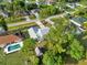 An aerial view of the home with a driveway, backyard shed, and proximity to a neighboring pool at 2776 Tusket Ave, North Port, FL 34286