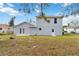 Back exterior view of a two-story home with lawn at 2776 Tusket Ave, North Port, FL 34286