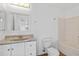 Bright bathroom with a single vanity, neutral walls, and combination tub/shower at 2776 Tusket Ave, North Port, FL 34286