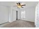 Cozy bedroom offering neutral carpeting, a ceiling fan, and a closet for storage at 2776 Tusket Ave, North Port, FL 34286